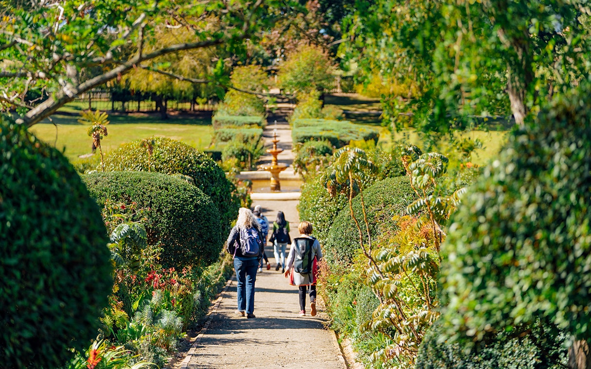 Visitors walking through the Government Garden at Port Arthur Historic Site.