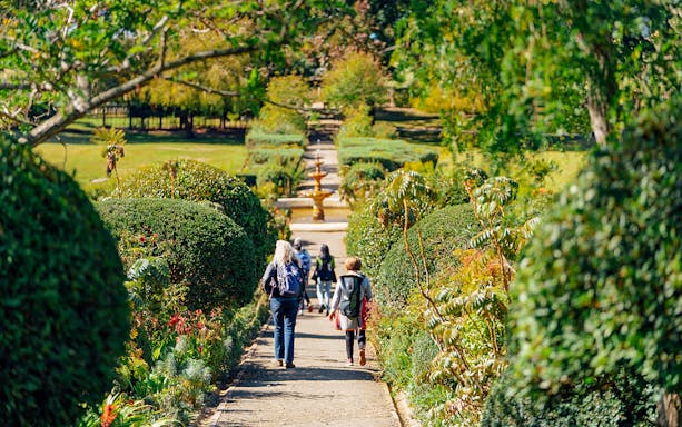 Visitors walking through the Government Garden at Port Arthur Historic Site.