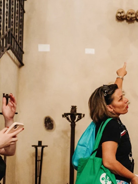 Tourists observing skull cross in Capuchin Crypts, Rome.