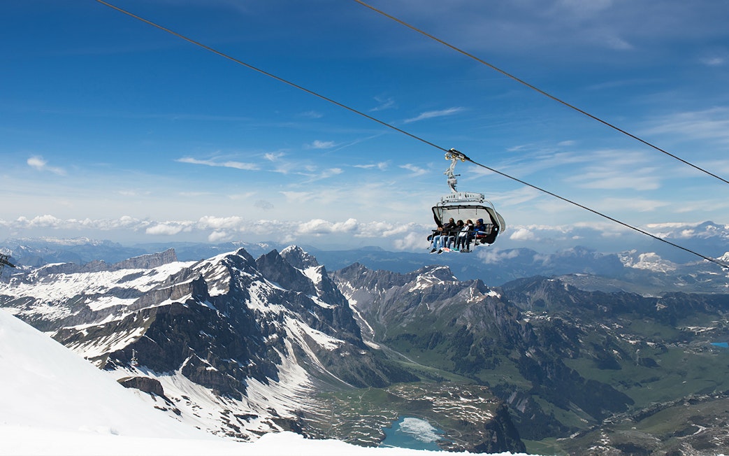 Ice Flyer chairlift over snowy peaks at Mount Titlis, Switzerland.