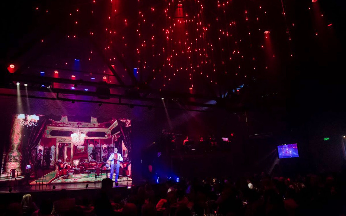 Stage performance at Madero Tango Show with vibrant lighting and audience.