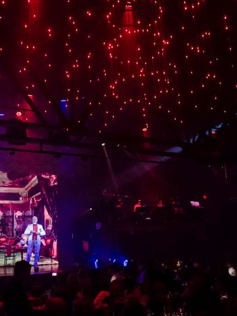 Stage performance at Madero Tango Show with vibrant lighting and audience.