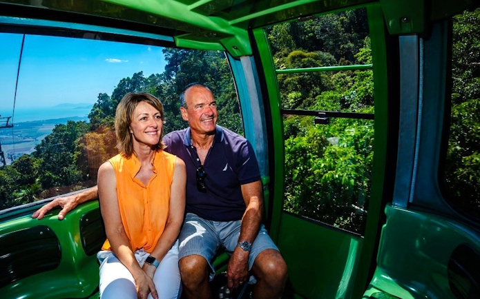 Couple enjoying views from Skyrail Rainforest Cableway on Kuranda tour.