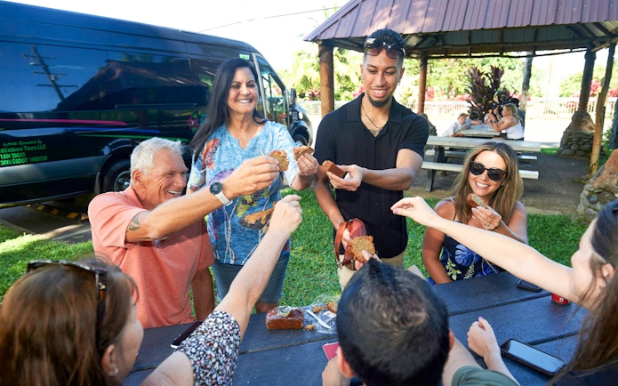 Group enjoying banana bread on Road to Hana Adventure Tour, Maui, Hawaii.