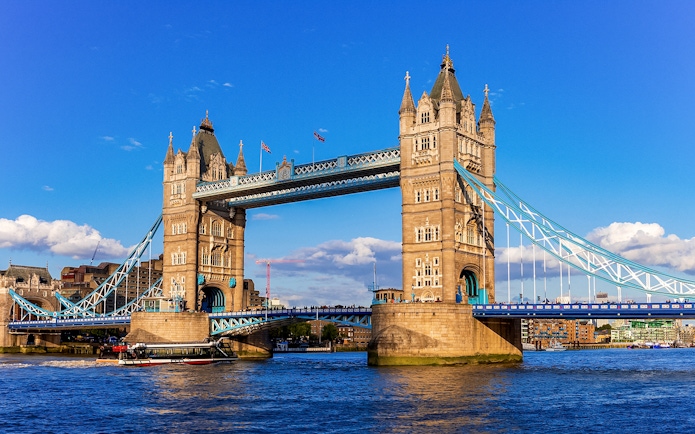 Tower Bridge in London with raised bascules, viewed from the River Thames.