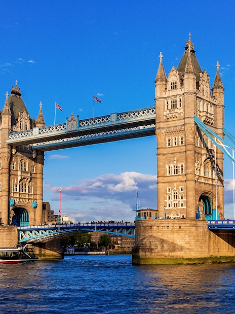 Tower Bridge in London with raised bascules, viewed from the River Thames.