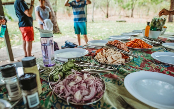Picnic setup with sliced meats and vegetables on a table during Litchfield Public Day Tour.