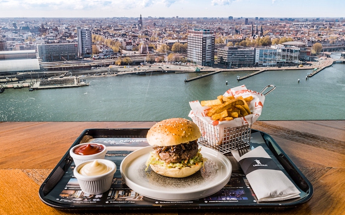 ADAM Lookout view with burger and fries at Panorama Restaurant, Amsterdam.