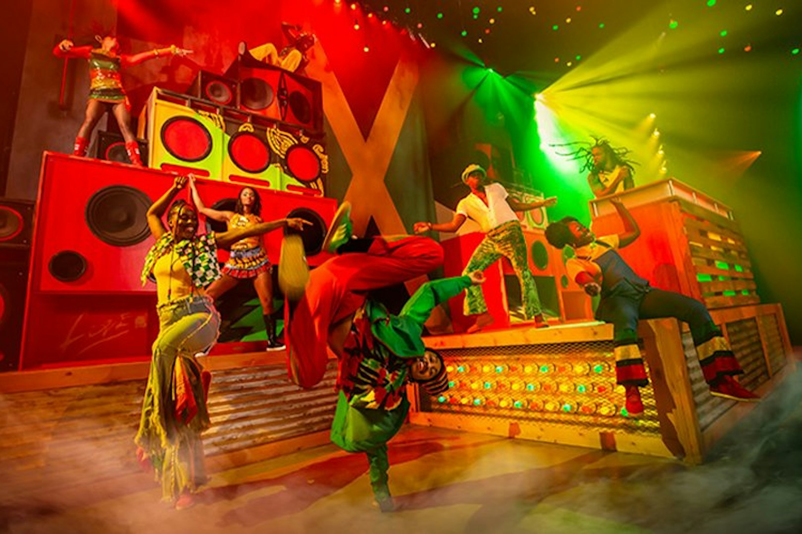 Performers dancing energetically on stage at Bob Marley The Show, Vegas.