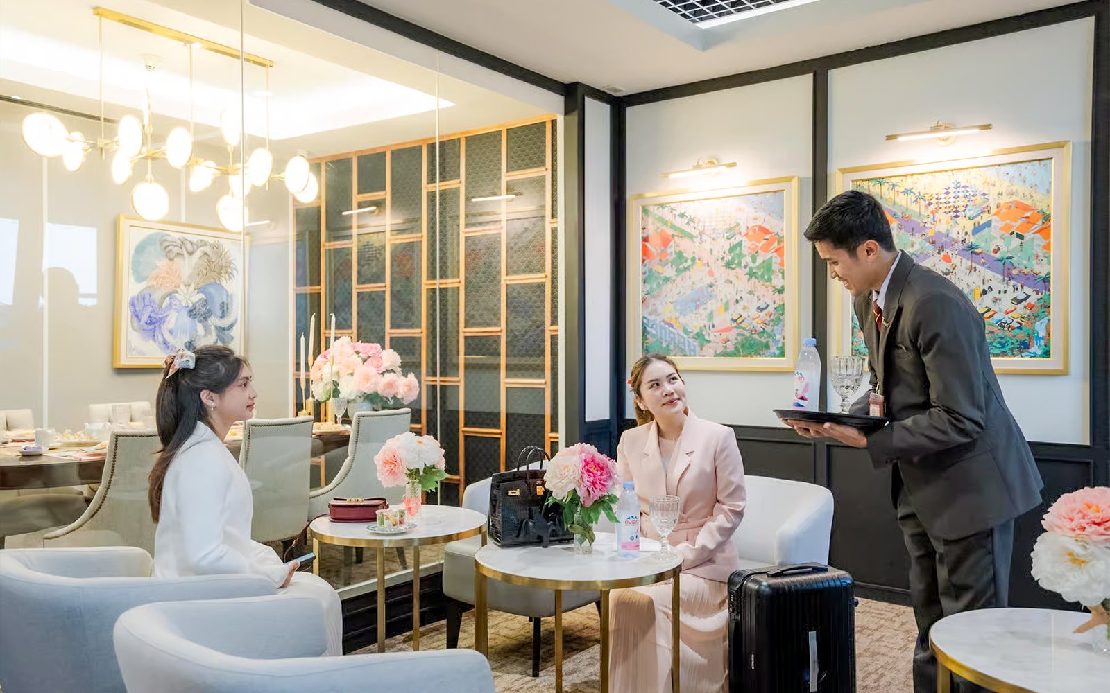 VIP lounge service at Donmuang Airport with guests being served refreshments.