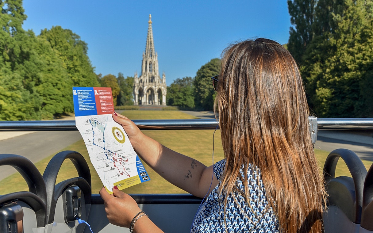 Tourist on Brussels bus tour holding map with view of the Church of Laeken.