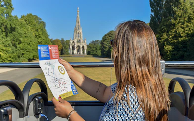 Tourist on Brussels bus tour holding map with view of the Church of Laeken.