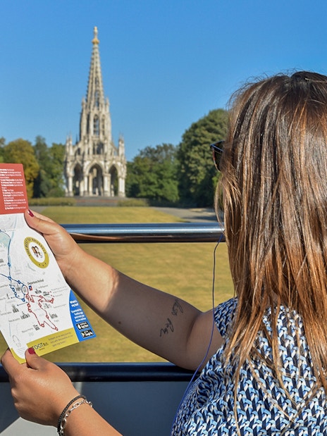 Tourist on Brussels bus tour holding map with view of the Church of Laeken.