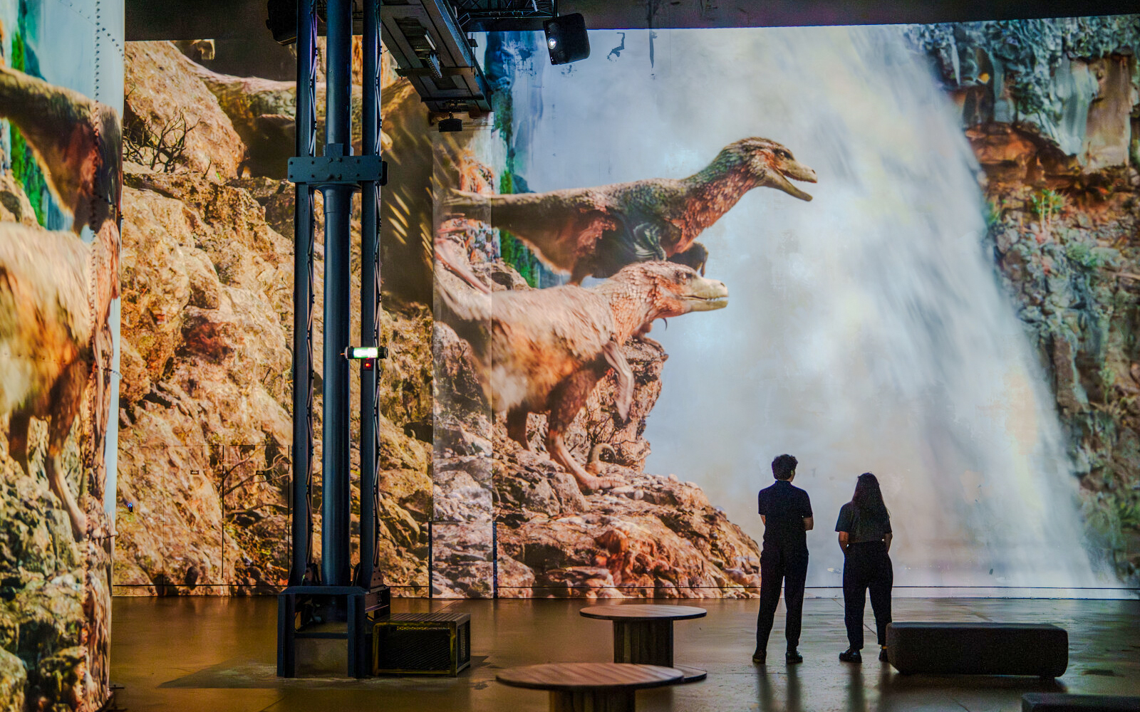 Dinosaurs projected on a wall at Prehistoric Planet exhibition, Atelier des Lumières.