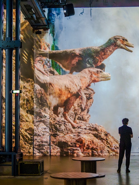 Dinosaurs projected on a wall at Prehistoric Planet exhibition, Atelier des Lumières.