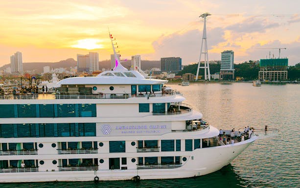Aerial view of Ambassador cruise ship in Ha Long Bay, Vietnam at sunset.