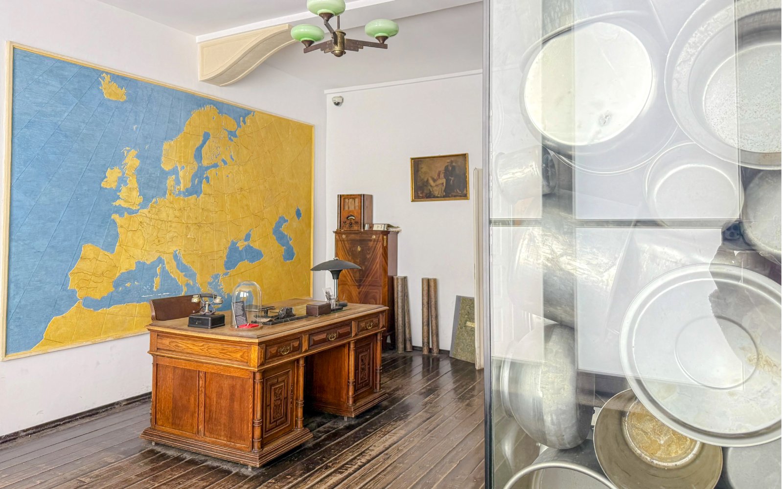 Oskar Schindler’s Factory exhibit with a wooden desk and large Europe map.
