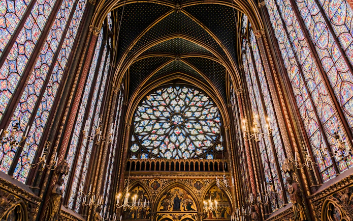 Stained glass windows and vaulted ceiling inside Sainte Chapelle, Paris.