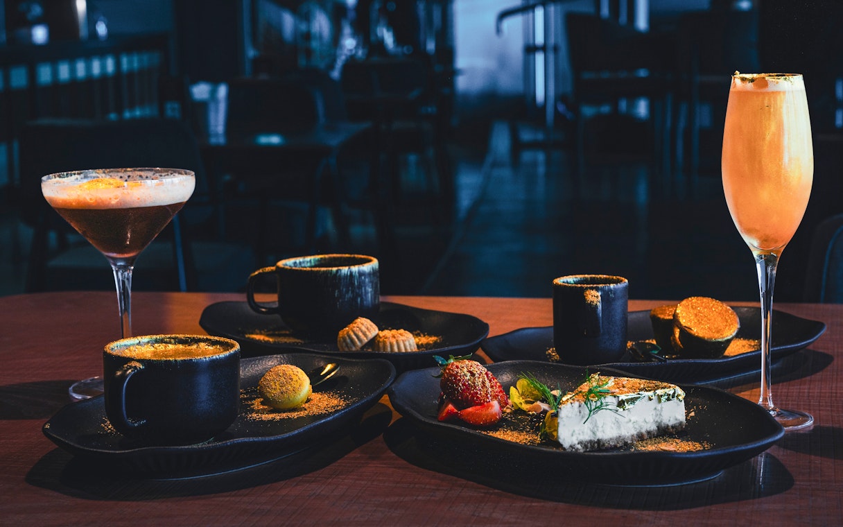 Sky 52 Restaurant table with coffee, dessert, and cocktails at Sky View Observatory, Dubai.