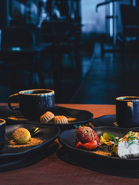 Sky 52 Restaurant table with coffee, dessert, and cocktails at Sky View Observatory, Dubai.