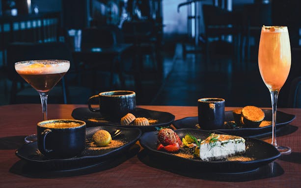 Sky 52 Restaurant table with coffee, dessert, and cocktails at Sky View Observatory, Dubai.