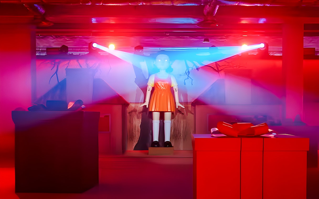 Squid Games experience setup with iconic doll in London venue.