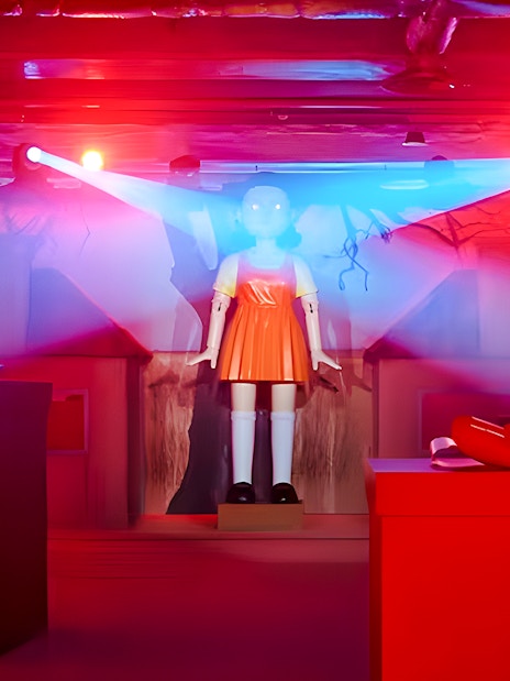 Squid Games experience setup with iconic doll in London venue.