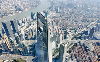 Shanghai skyline view from the top of Shanghai Tower, featuring skyscrapers and the Huangpu River.