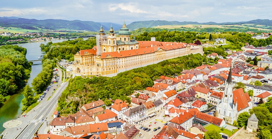 Aerial view of Melk Monastery in Austria with surrounding town and river.