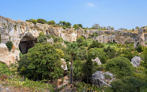 Neapolis Archaeological Park, lush greenery and ancient rock formations, Syracuse.