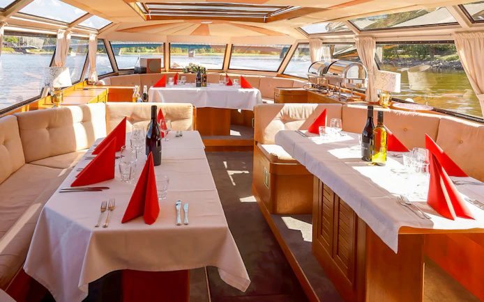 Luxurious dining setup on a Helsinki private champagne cruise boat with scenic views.