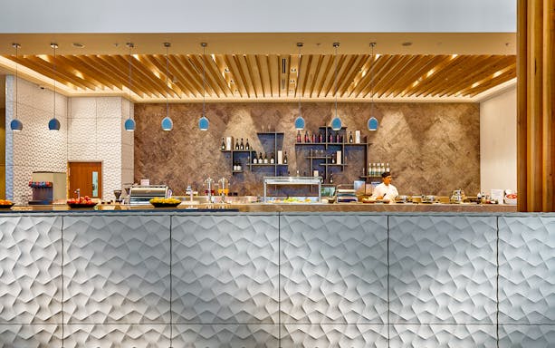 Brisbane Plaza Premium Lounge buffet area with chef and modern decor.