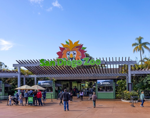 San Diego Zoo entrance with visitors and colorful sign.