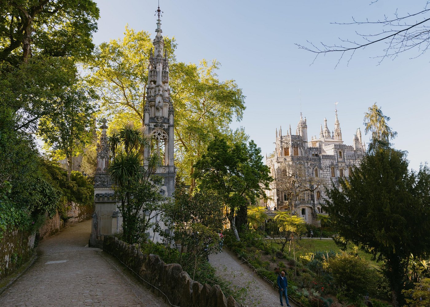 Quinta da Regaleira's ornate facade with lush gardens in Sintra, Portugal.