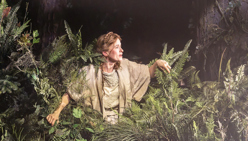 Performer in forest setting during "Into The Woods" production.