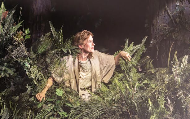 Performer in forest setting during "Into The Woods" production.