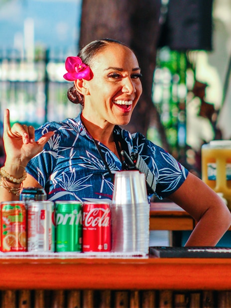 Hawaiian woman with flower in hair at Moana Luau bar, Hawaii.