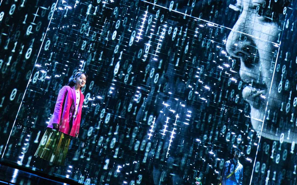Performer on stage during Maybe Happy Ending Broadway show with digital backdrop.