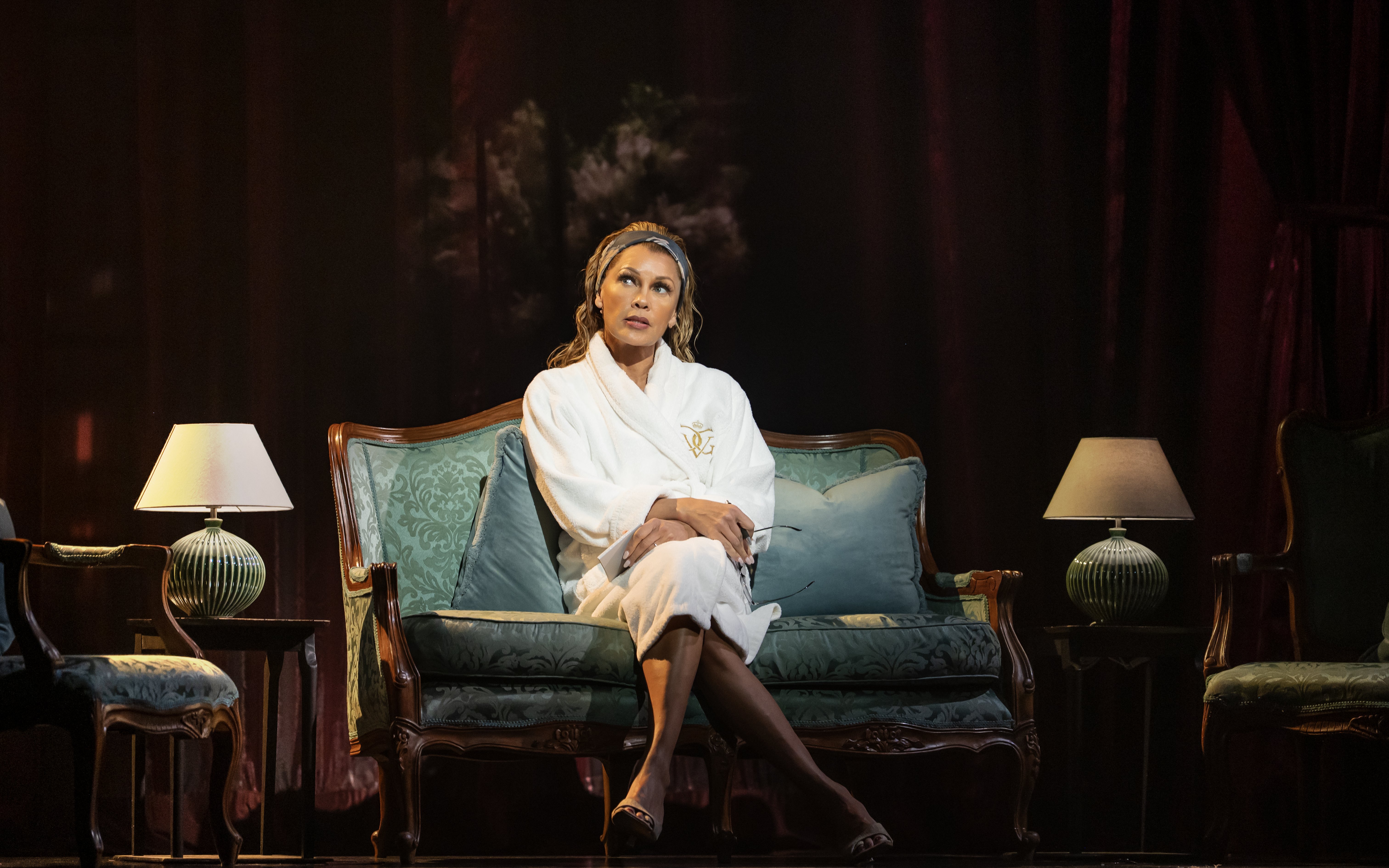 Actor seated on stage during The Devil Wears Prada West End show performance.