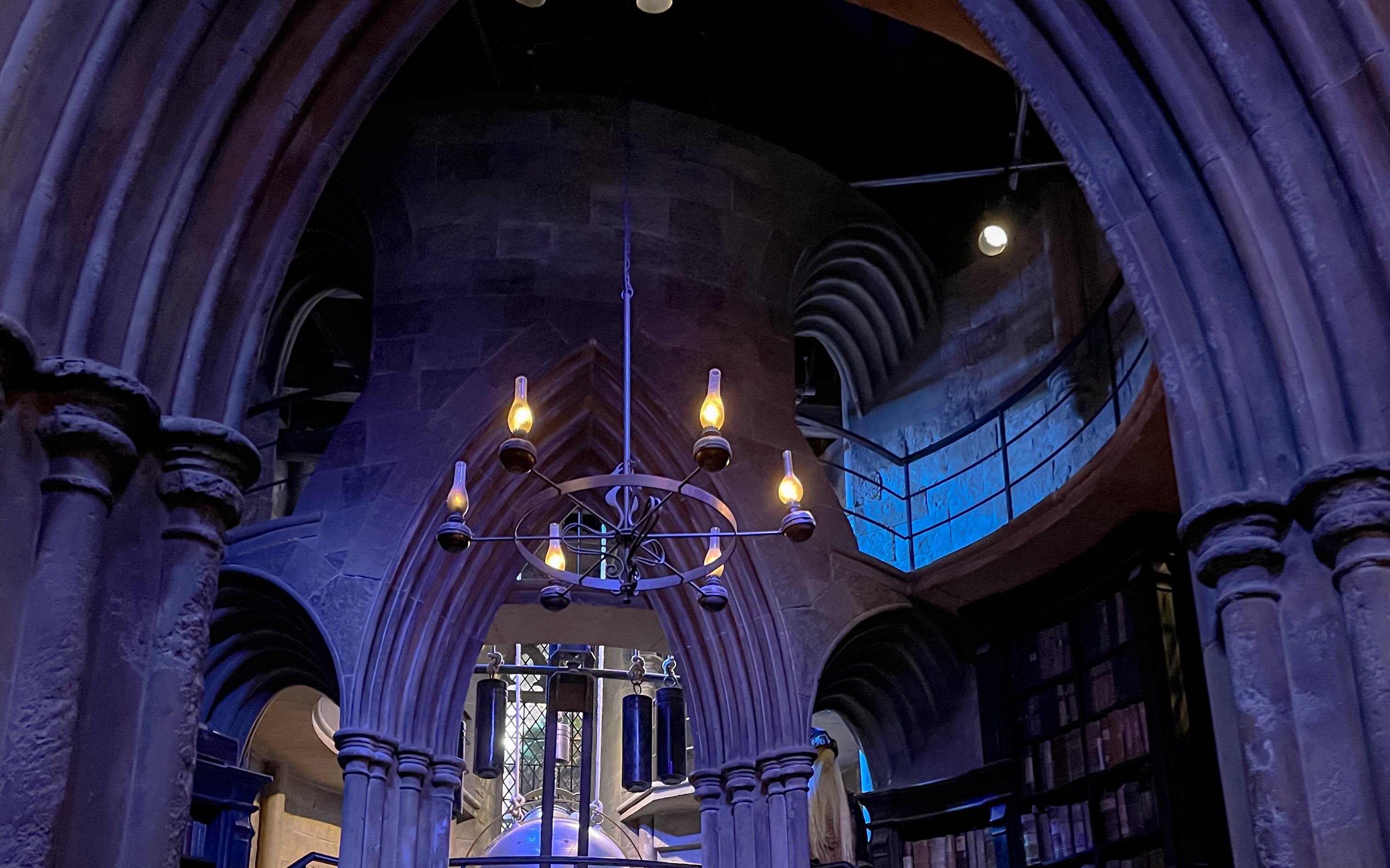 Professor Dumbledore's office with stone arches and a chandelier.
