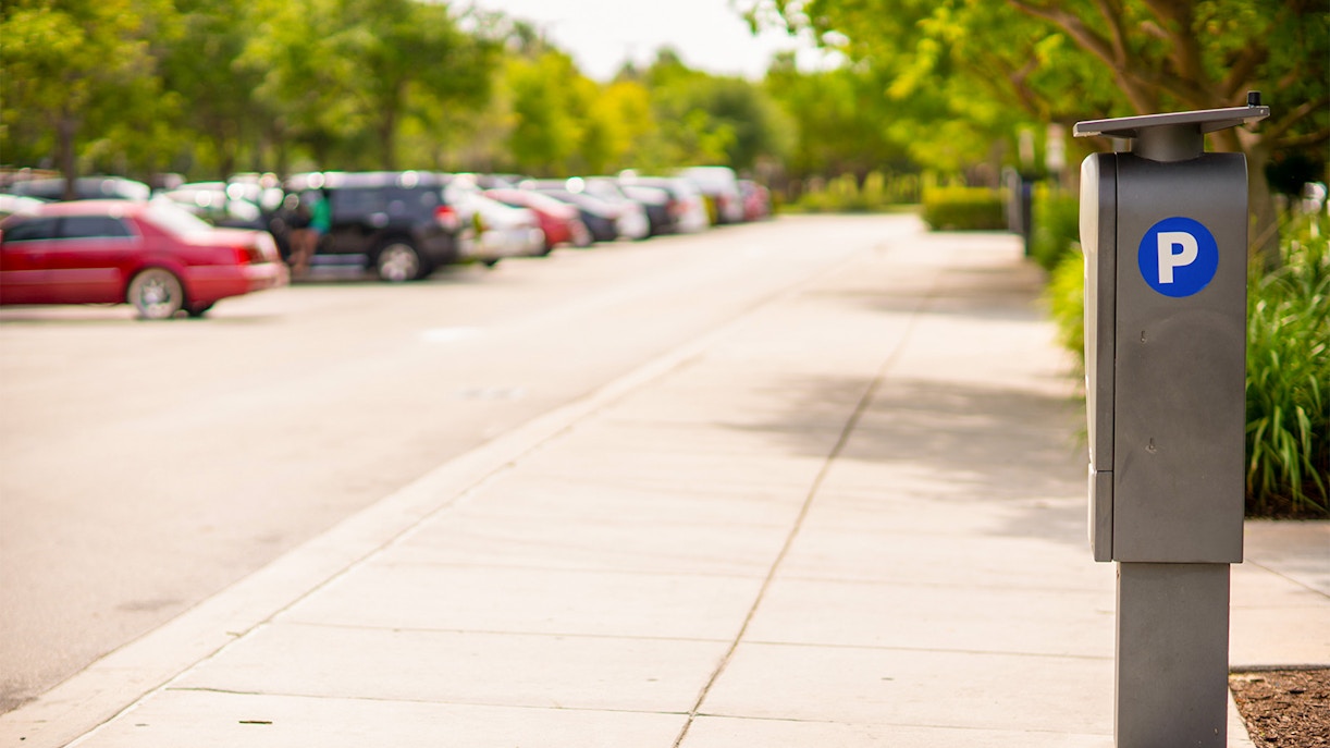 Parking area at Parque Warner Madrid with cars and parking meter.