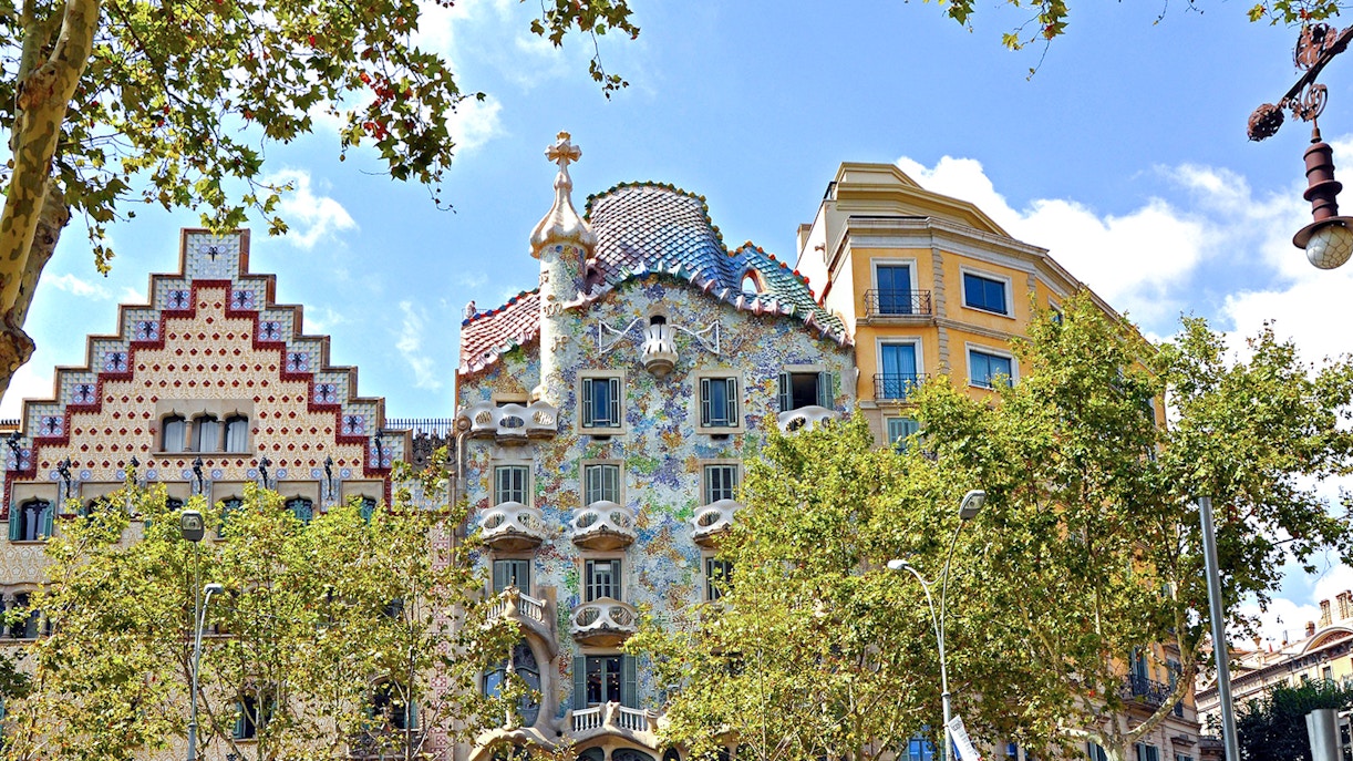 Casa Batlló facade with colorful mosaic tiles in Barcelona, near Casa Mila.