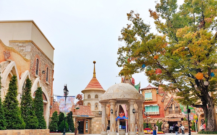 Gyeongju World entrance with colorful architecture and trees, South Korea.