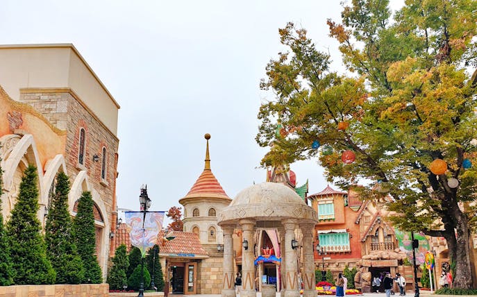 Gyeongju World entrance with colorful architecture and trees, South Korea.