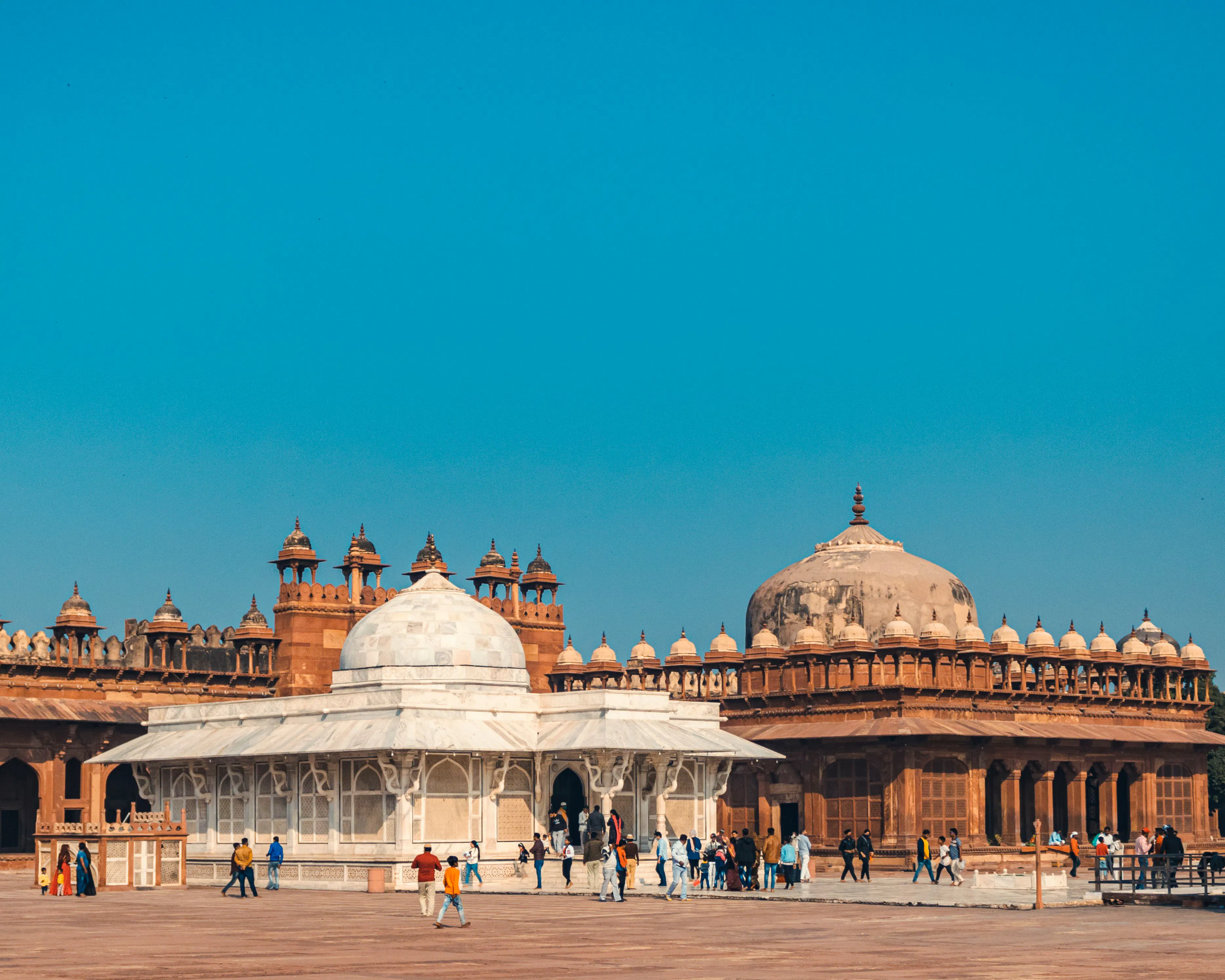 Fatehpur Sikri courtyard with tourists, Agra to Jaipur transfer tour.