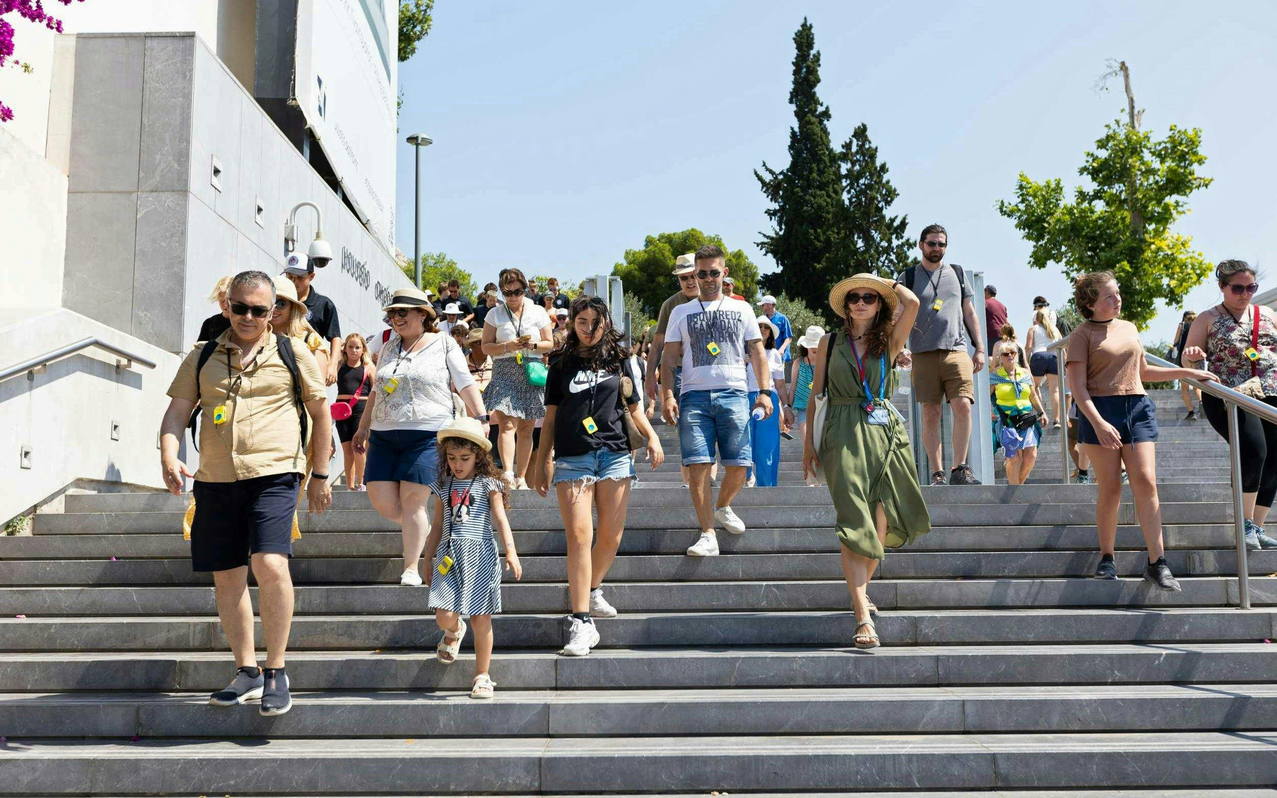Visitors descending steps at Acropolis Museum, Athens during a guided tour.