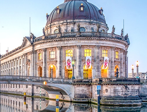 Bode Museum on Museum Island, Berlin, reflected in the Spree River at dusk.