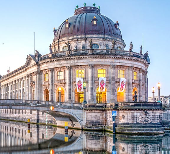 Bode Museum on Museum Island, Berlin, reflected in the Spree River at dusk.