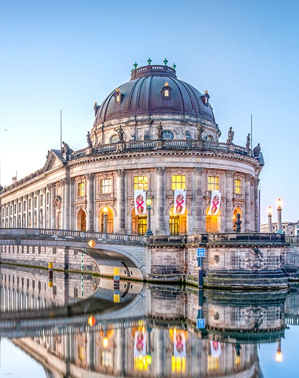 Bode Museum on Museum Island, Berlin, reflected in the Spree River at dusk.