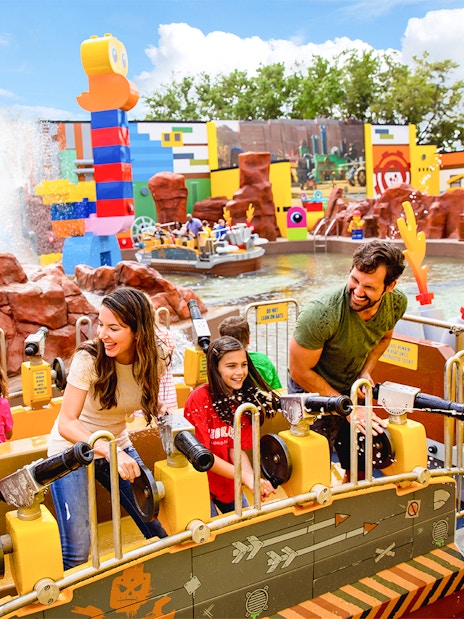 Families enjoying the Battle of Bricksburg water ride at LEGOLAND Theme Park, Florida.
